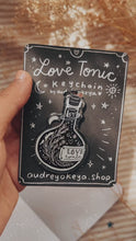 Load and play video in Gallery viewer, Potion Love Tonic Keychain